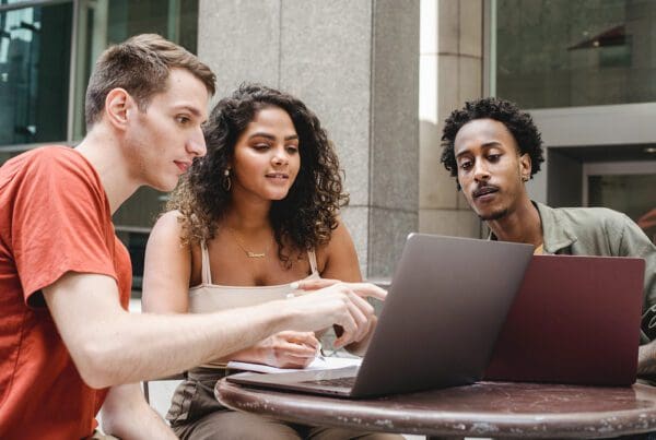 young people looking at their laptops