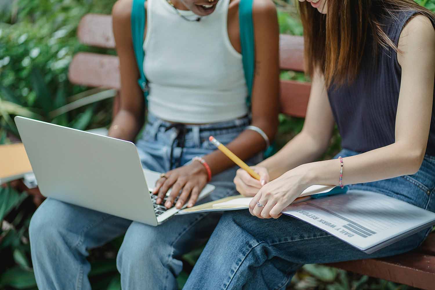 Online students with laptop and taking notes