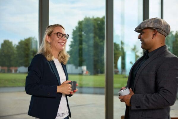 A female and male researcher discussing outside